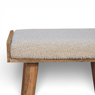 Wooden bench with a textured beige cushion on a white background