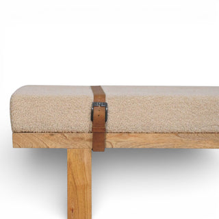 Beige cushioned bench with wooden frame and leather strap on a white background