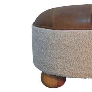 Brown cushioned ottoman with textured base on a white background