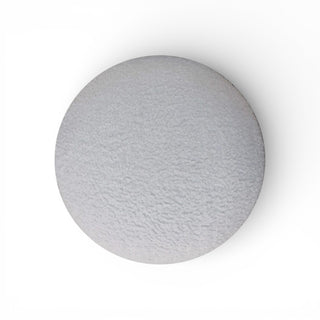 Round gray ottoma on a white background