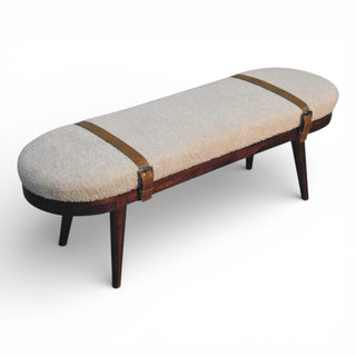 Long bench with textured cushion and brown straps on a white background