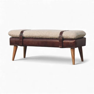 Back view of the cream bouclé bench showing the brown buffalo leather strap accents and the Nordic solid wood legs in an oak-style finish.