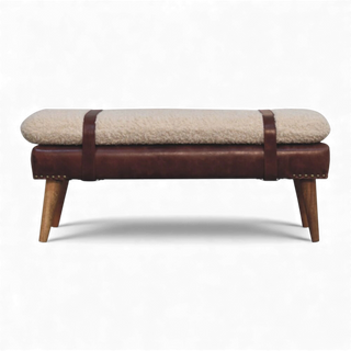 End view of the cream bouclé bench showing the slim cushioned seat profile, brown buffalo leather strap accent, and oak-style Nordic wood legs.