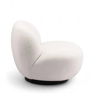 Angled view of cream boucle accent chair showing steel base and textured fabric