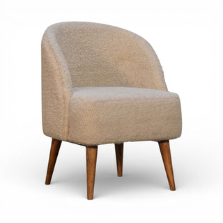 Beige armchair with wooden legs on a white background