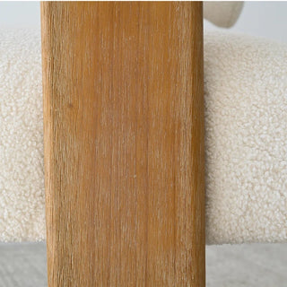 Close-up detail of loveseat showing solid oak wood frame elements and beige boucle fabric texture