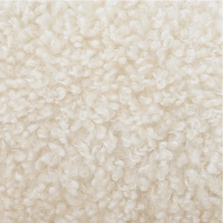 Close-up of beige sherpa boucle fabric texture on curved loveseat showing soft, tactile surface