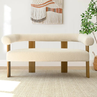 Curved open-back loveseat styled in bright living space showcasing its spacious design and architectural profile