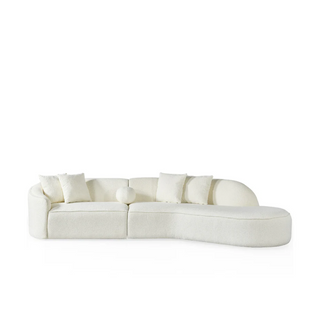 White boucle curved sectional sofa with asymmetrical design, rounded arms, and black legs shown from front angle