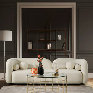 Boucle sofa displayed in contemporary living room with accent decor and dark walls