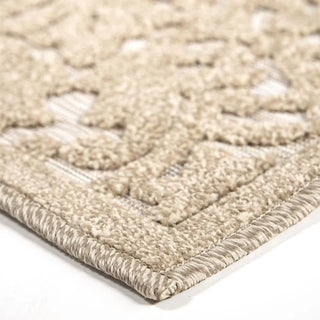 Close-up detail of boucle rug showing damask pattern texture and high-low construction