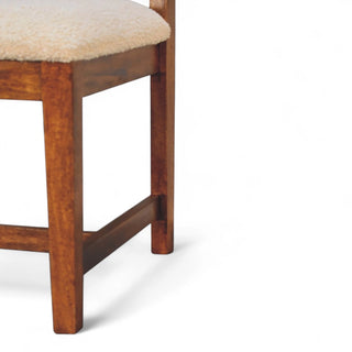 Wooden chair with a beige cushion on a white background