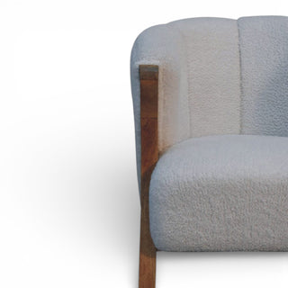 Gray upholstered chair with wooden armrest on a white background