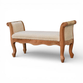 Wooden bench with beige cushion on a white background