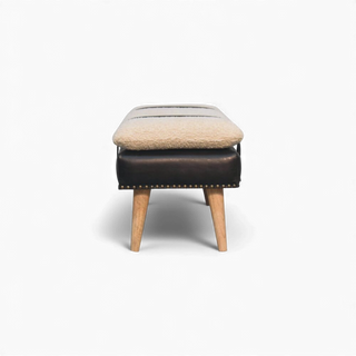 Stool with a brown leather seat and beige cushion on a white background
