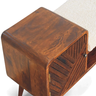 Close-up of dark wood bench texture and beige seat showing fine craftsmanship and grain pattern.