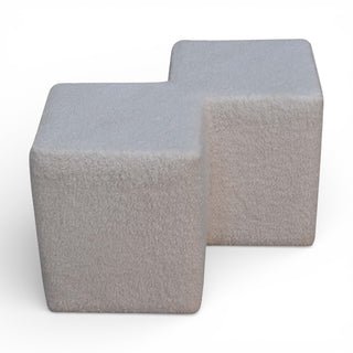 Two gray cube-shaped ottomans on a white background