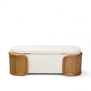 Cream boucle storage bench with woven rattan sides and curved legs shown from front angle in bedroom setting