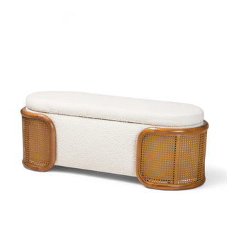 Cream boucle storage bench with woven rattan sides and curved design shown from front angle against white background