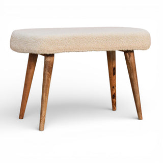 Beige cushioned stool with wooden legs on a white background