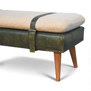 Bench with sheepskin cushion and green leather strap on a white background