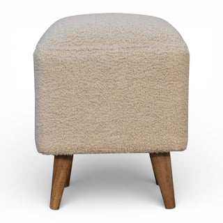 Beige textured ottoman with wooden legs on a white background