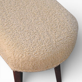 Round ottoman with textured beige cushion on a white background
