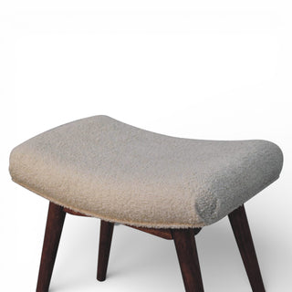 Stool with a textured gray cushioned seat and wooden legs on a white background