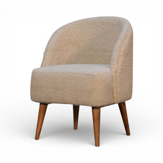 Beige armchair with wooden legs on a white background