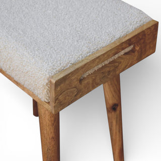 Wooden stool with a textured white cushion on a white background