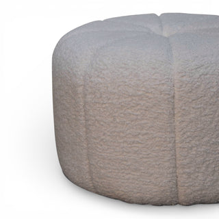 Round gray textured ottoman on a white background