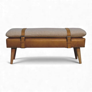 Bench with brown leather straps and beige cushion on a white background