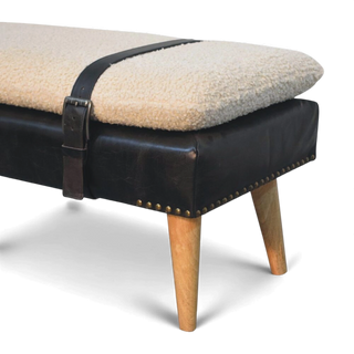 Bench with black leather and beige cushion on a white background