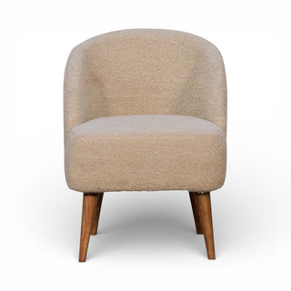 Beige armchair with wooden legs on a white background