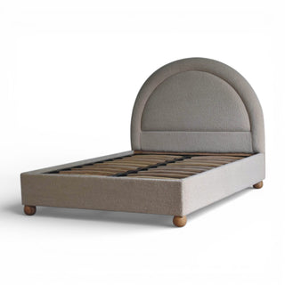 Gray upholstered bed with wooden slats on a white background