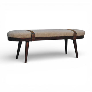 Beige upholstered bench with dark wooden legs on a white background