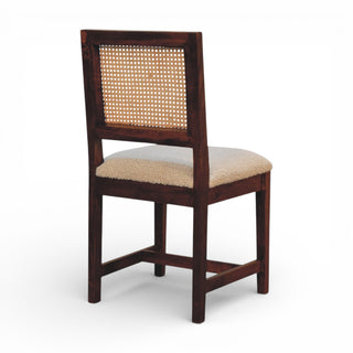Wooden chair with a woven backrest and beige cushion on a white background