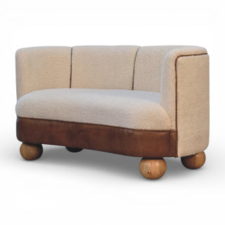 Small beige and brown sofa with wooden legs on a white background
