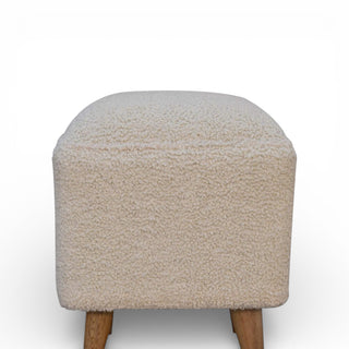 Beige textured stool with wooden legs on a white background