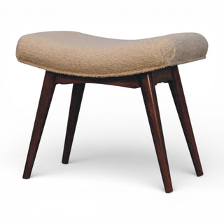 Beige cushioned stool with wooden legs on a white background