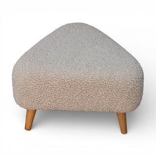 Triangular ottoman with textured beige cushion and wooden legs on a white background