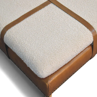 Brown ottoman with white cushion on a white background
