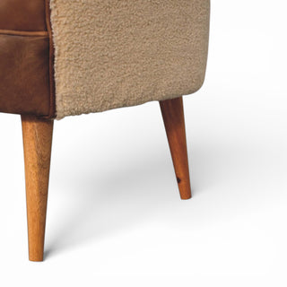 Close-up of a brown upholstered chair with wooden legs on a white background