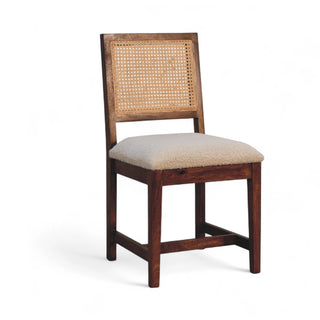 Wooden chair with wicker backrest and beige cushion on a white background