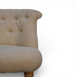 Beige upholstered chair with tufted backrest on a white background