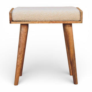 Wooden stool with a cushioned seat on a white background