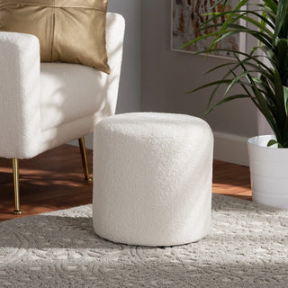 Ivory cylindrical ottoman in living room with chair