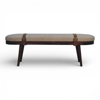 Decorative bench with wooden legs and upholstered seat on a white background