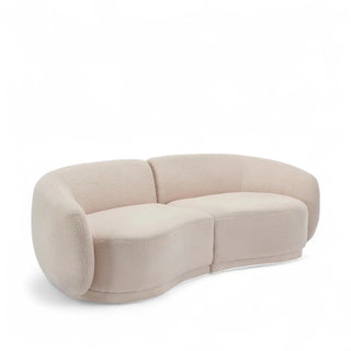 Side angle view of beige boucle loveseat showing rolled arm detail and curved form