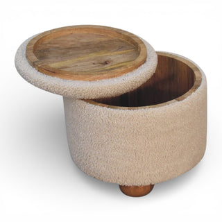 Round wooden ottoman with a textured beige cover on a white background